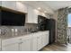 Kitchen area featuring stainless steel appliances, stone counter tops, and dark backsplash at 4800 S Ocean Blvd. # 1221, North Myrtle Beach, SC 29582