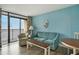 Living room with sofa, chair and table, access to balcony and ocean views at 4800 S Ocean Blvd. # 1221, North Myrtle Beach, SC 29582