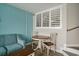 Living room with sofa, chairs, table, and large window with shutters at 4800 S Ocean Blvd. # 1221, North Myrtle Beach, SC 29582