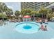 Relaxing outdoor pool featuring a charming mushroom waterfall, surrounded by palm trees and lounge chairs at 4800 S Ocean Blvd. # 1221, North Myrtle Beach, SC 29582