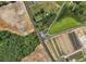 Aerial view of a building at a crossroads, surrounded by diverse agricultural fields and a small pond at 4860 Highway 378, Conway, SC 29527