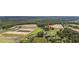 A picturesque aerial shot showcasing the property's expansive land, pond, and proximity to farmlands at 4860 Highway 378, Conway, SC 29527