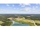 Expansive aerial view of property highlighting fields, ponds, and surrounding landscape under a partly cloudy sky at 4860 Highway 378, Conway, SC 29527