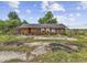 Single story brick home with overgrown landscaping and neglected surroundings at 4860 Highway 378, Conway, SC 29527