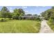 Charming single-story home featuring a lush green lawn and mature trees, creating a private retreat at 4860 Highway 378, Conway, SC 29527