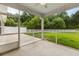 Relaxing screened-in back porch provides a tranquil outdoor seating area with views of a well-maintained yard at 5115 Huston Rd., Conway, SC 29526