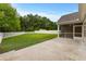 Large backyard with manicured lawn, white fencing, and a screened in back porch at 5115 Huston Rd., Conway, SC 29526