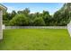 Spacious backyard featuring lush green lawn and white fencing, perfect for outdoor activities at 5115 Huston Rd., Conway, SC 29526