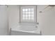 Bathroom featuring a soaking tub with tile surround and a privacy window at 5115 Huston Rd., Conway, SC 29526