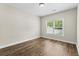 Bright bedroom featuring wood-look floors and a large window that lets in plenty of natural light at 5115 Huston Rd., Conway, SC 29526