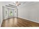 Primary bedroom with tray ceilings, wood floors, a ceiling fan, and abundant natural light at 5115 Huston Rd., Conway, SC 29526
