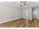 Spacious bedroom with wood floors, tray ceiling, ceiling fan, and ensuite bathroom access at 5115 Huston Rd., Conway, SC 29526