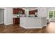 Kitchen with granite countertops, stainless steel appliances, hardwood floors, and breakfast bar seamlessly connected to the living room at 5115 Huston Rd., Conway, SC 29526