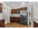 Modern kitchen with stainless steel appliances, granite countertops, wood cabinets, and hardwood floors at 5115 Huston Rd., Conway, SC 29526