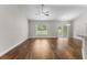 Bright open-plan living room with vaulted ceiling, hardwood floors, fan, and sliding doors leading to the outside at 5115 Huston Rd., Conway, SC 29526