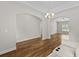 Open-concept layout showcasing wood floors, arched doorways, modern lighting, and access to other living spaces at 5115 Huston Rd., Conway, SC 29526