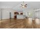 Expansive living room featuring vaulted ceilings, hardwood floors, and an open layout blending living and kitchen spaces at 5115 Huston Rd., Conway, SC 29526