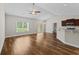 Bright open-plan living room with vaulted ceiling, hardwood floors, fan, and sliding doors leading to the outside at 5115 Huston Rd., Conway, SC 29526