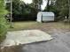 Backyard with mature trees and detached storage shed at 514 Palm St., Georgetown, SC 29440