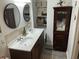 Bright bathroom featuring dual sinks, two mirrors, and cabinet storage with decorative baskets and towels at 514 Palm St., Georgetown, SC 29440