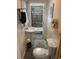 Well-lit bathroom featuring a pedestal sink, toilet, and walk-in shower, all decorated with neutral tones at 514 Palm St., Georgetown, SC 29440