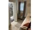 Inviting bedroom with a comfortable bed, window, and a peek into the en-suite bathroom with a shower at 514 Palm St., Georgetown, SC 29440