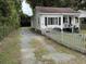 Charming single-Gathering home with a white picket fence, well-maintained lawn, and a cozy front porch at 514 Palm St., Georgetown, SC 29440