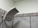 Modern shower head with gray, large-format wall tiles create an inviting and luxurious bathing experience at 514 Palm St., Georgetown, SC 29440