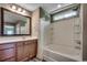 Bright bathroom features a shower and tub combo with a single sink vanity and framed mirror at 5153 Country Pine Dr., Myrtle Beach, SC 29579