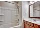 Bright bathroom features a shower and tub combo with a single sink vanity and framed mirror at 5153 Country Pine Dr., Myrtle Beach, SC 29579