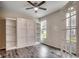 Bright bedroom has hardwood floors, a ceiling fan, and built-in shelving at 5153 Country Pine Dr., Myrtle Beach, SC 29579