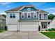 Charming two-story home with a three-car garage, gray siding, and red shutters at 5153 Country Pine Dr., Myrtle Beach, SC 29579