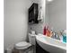 Bathroom features a toilet, sink, cabinet, and essential toiletries, all in close proximity at 517 Cardinal Dr., Conway, SC 29526