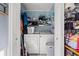 Open utility closet reveals a washer, dryer, and various household supplies for convenience at 517 Cardinal Dr., Conway, SC 29526
