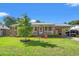 Charming single-story brick home with a well-manicured lawn, mature tree, and welcoming front porch in a desirable location at 517 Cardinal Dr., Conway, SC 29526