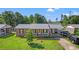 Charming brick home featuring a well-manicured lawn, covered parking, and a welcoming front porch at 517 Cardinal Dr., Conway, SC 29526