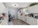 Bright kitchen featuring white cabinets, neutral countertops, and modern appliances at 517 Cardinal Dr., Conway, SC 29526