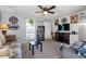 Comfortable living room featuring light gray walls, ceiling fan, and entertainment center with fireplace at 517 Cardinal Dr., Conway, SC 29526