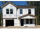 New two-story home under construction featuring a two-car garage and classic window design at 5362 Hampton Rd., Conway, SC 29527