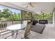 Spacious back porch with ceiling fans, outdoor furniture, and wooded views at 5407 N Ocean Blvd., Myrtle Beach, SC 29577