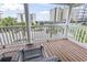 Relaxing balcony features comfortable seating with a view of palm trees and distant ocean views at 5407 N Ocean Blvd., Myrtle Beach, SC 29577