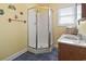 Bright bathroom featuring a corner shower with glass door and a single sink vanity with storage at 5407 N Ocean Blvd., Myrtle Beach, SC 29577