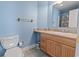 Bright blue bathroom featuring a single sink vanity and a toilet at 5407 N Ocean Blvd., Myrtle Beach, SC 29577