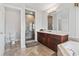 Bathroom featuring a walk-in shower with glass door and marble surround and vanity with marble countertop at 5407 N Ocean Blvd., Myrtle Beach, SC 29577