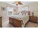 Cozy bedroom with decorative ceiling fan, wooden furniture, and plenty of natural light at 5407 N Ocean Blvd., Myrtle Beach, SC 29577