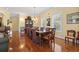 Elegant dining room featuring hardwood floors, a chandelier, and a large dining table set for hosting at 5407 N Ocean Blvd., Myrtle Beach, SC 29577