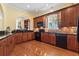 Spacious kitchen with wood cabinets, granite counters, and seamless flow to the living spaces at 5407 N Ocean Blvd., Myrtle Beach, SC 29577