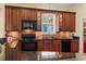 Well-equipped kitchen with granite countertops, custom cabinets, and modern black appliances at 5407 N Ocean Blvd., Myrtle Beach, SC 29577