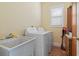 Functional laundry room with utility sink, washer, dryer, and cabinet storage at 5407 N Ocean Blvd., Myrtle Beach, SC 29577