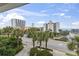 Balcony view showcasing palm trees, city buildings, and a distant ocean view for a relaxed atmosphere at 5407 N Ocean Blvd., Myrtle Beach, SC 29577